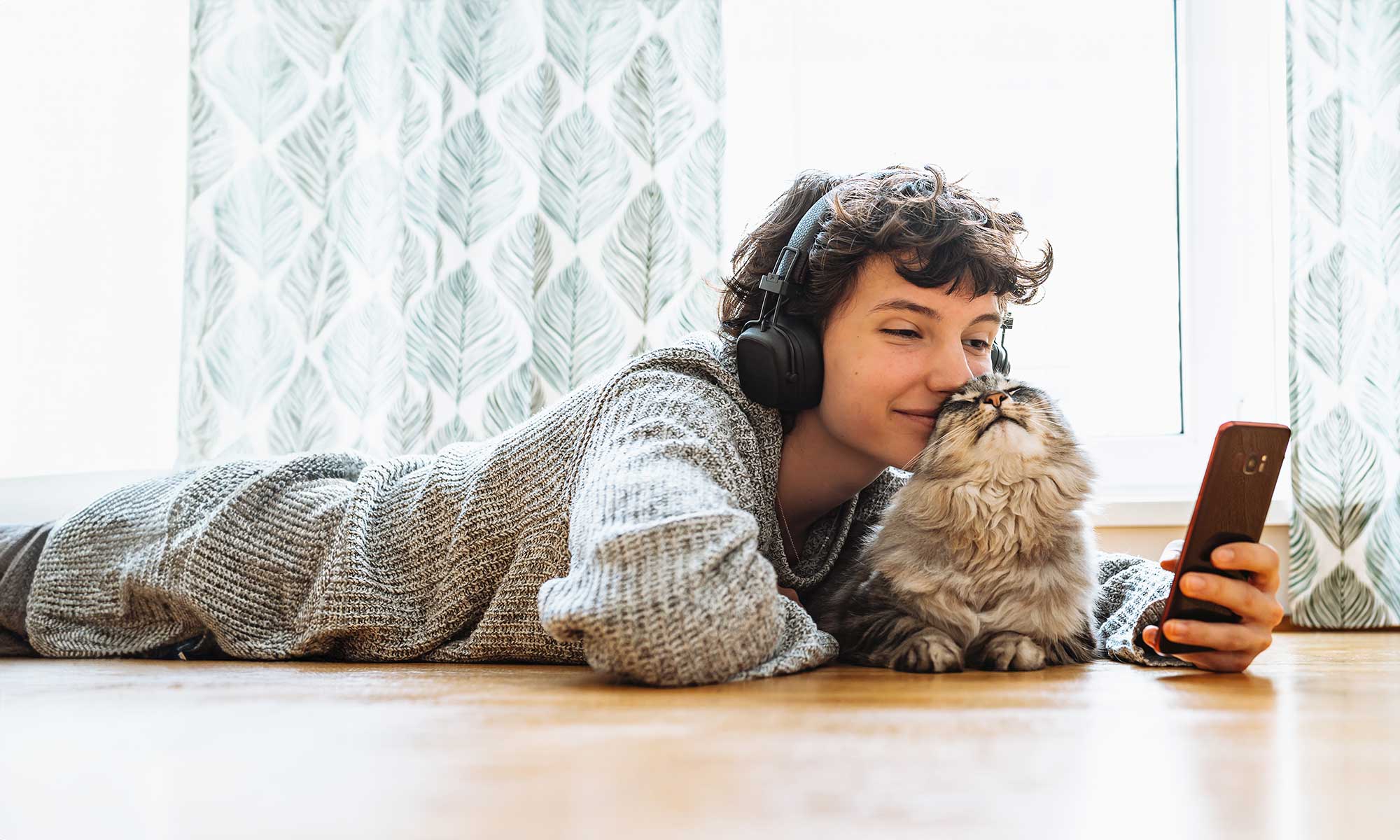 A young man holding a cat