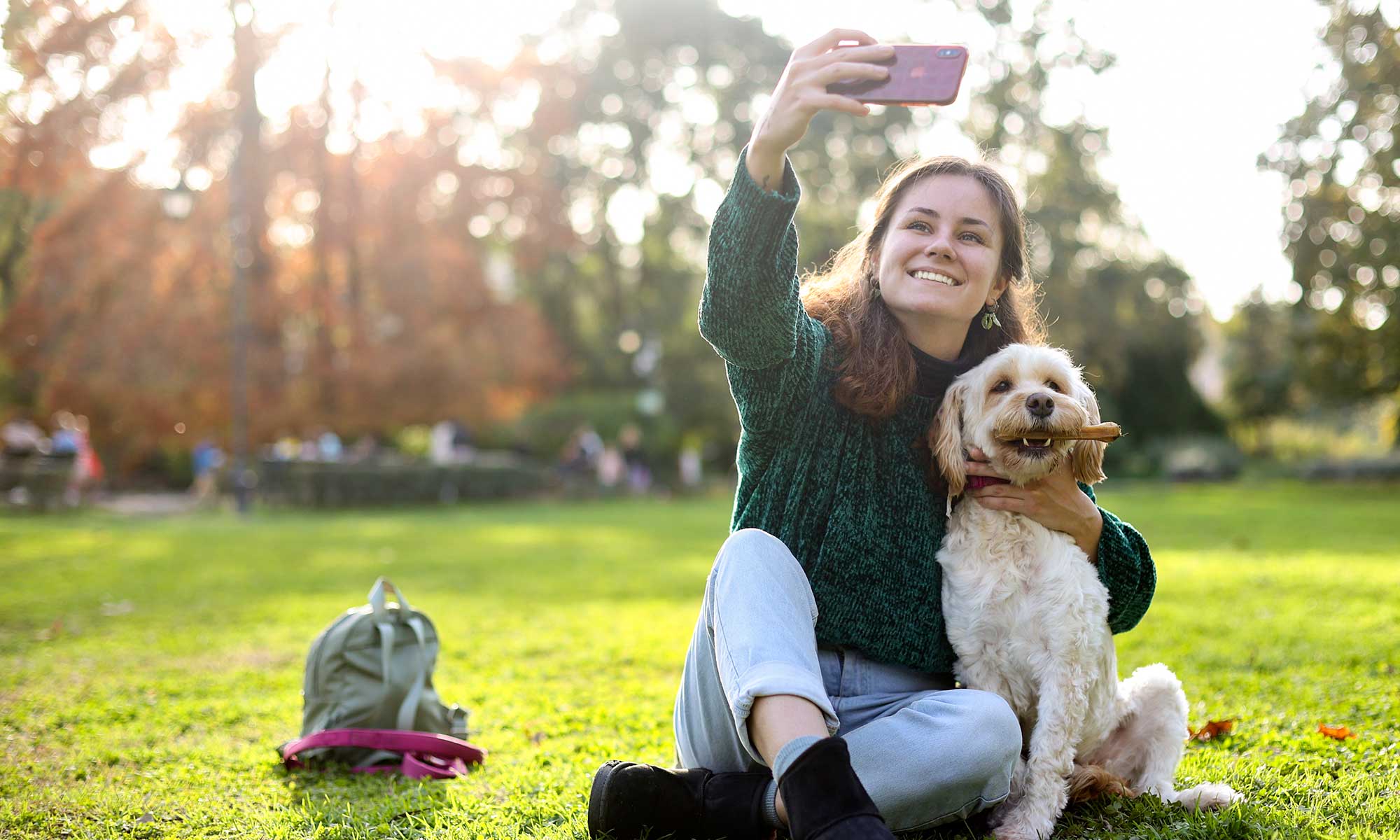 A woman taking a picture of her dog
