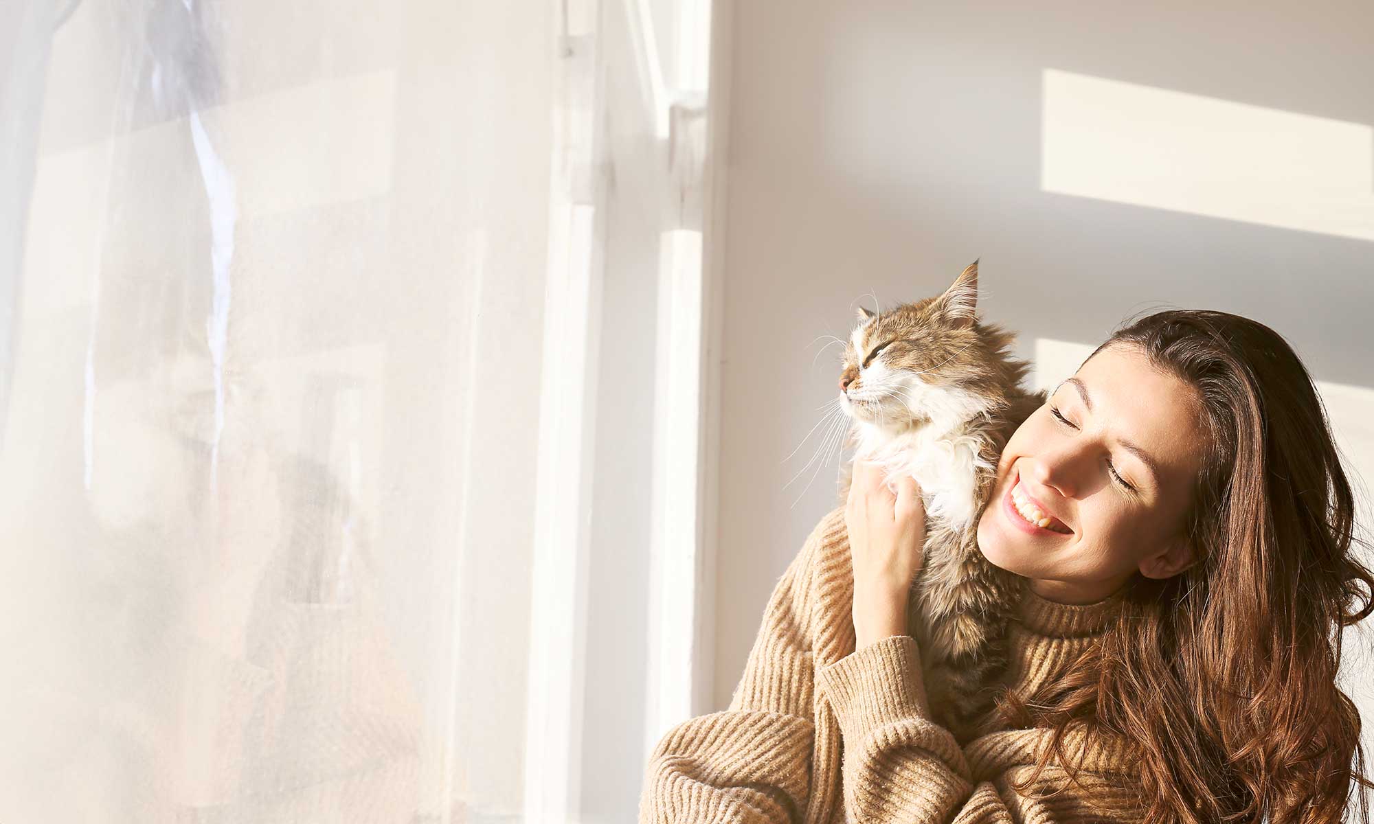 A woman cuddling her cat